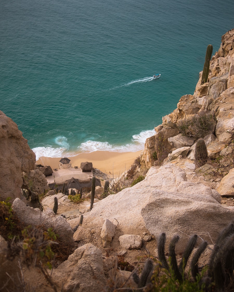 Ocean view with a tour boat below on top of Mt Solmar in Cabo San Lucas